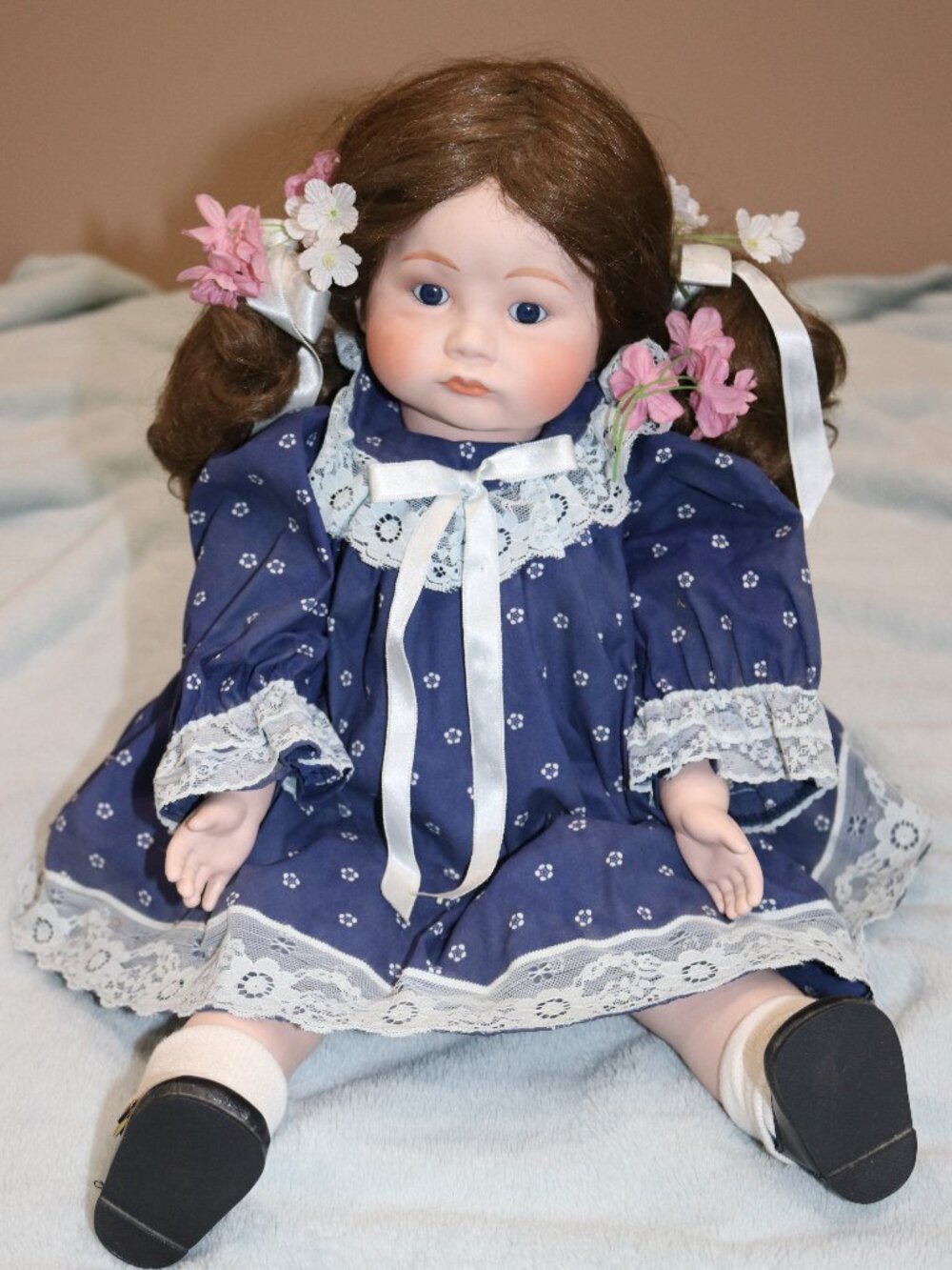 Vintage 1980s china doll with blue dress.